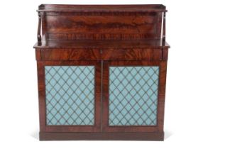 An early 19th Century mahogany chiffonier with single galleried shelf, raised on scroll supports