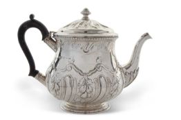 Edwardian silver teapot of slight baluster form, the hinged lid and body decorated with a fluted and