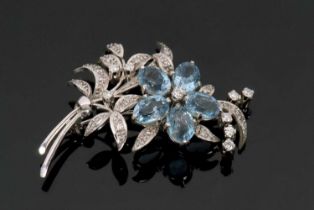 An 18ct white gold diamond and topaz floral brooch, the flower set with oval topaz petals and the