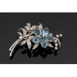 An 18ct white gold diamond and topaz floral brooch, the flower set with oval topaz petals and the