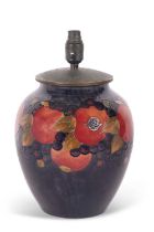 A large Moorcroft pomegranate lamp base, the top with metal cover, the lamp base 30cm high with