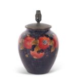 A large Moorcroft pomegranate lamp base, the top with metal cover, the lamp base 30cm high with