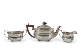 A George VI silver three piece tea service of rectangular form with fluted corners, applied