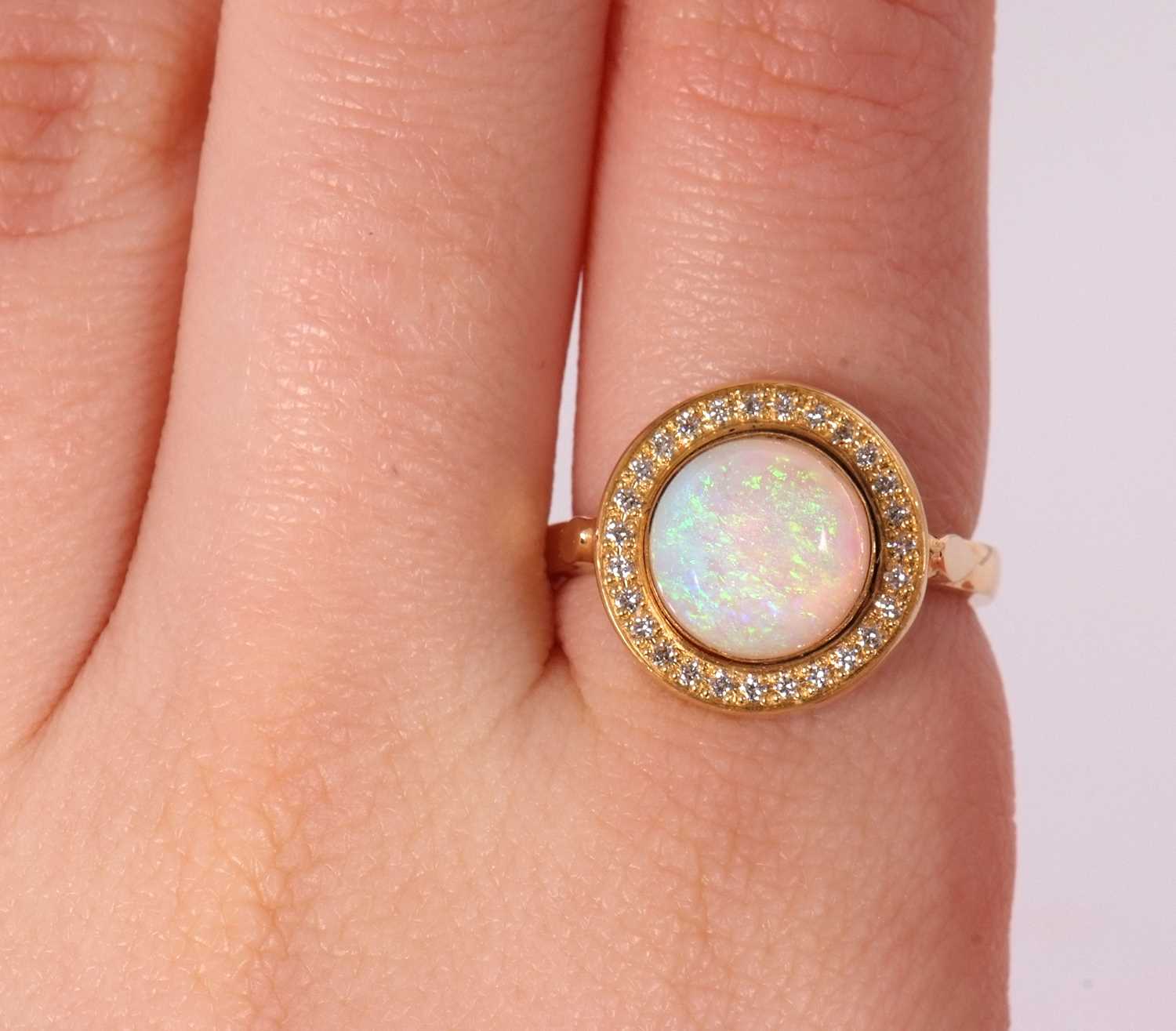 An opal and diamond ring, the round opal cabochon, approx. 9.4mm diameter, collet mounted and - Image 7 of 7