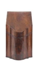 A Georgian mahogany knife box of hinged wedge form, the lid inlaid with shell decoration opening