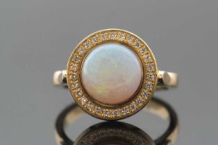 An opal and diamond ring, the round opal cabochon, approx. 9.4mm diameter, collet mounted and