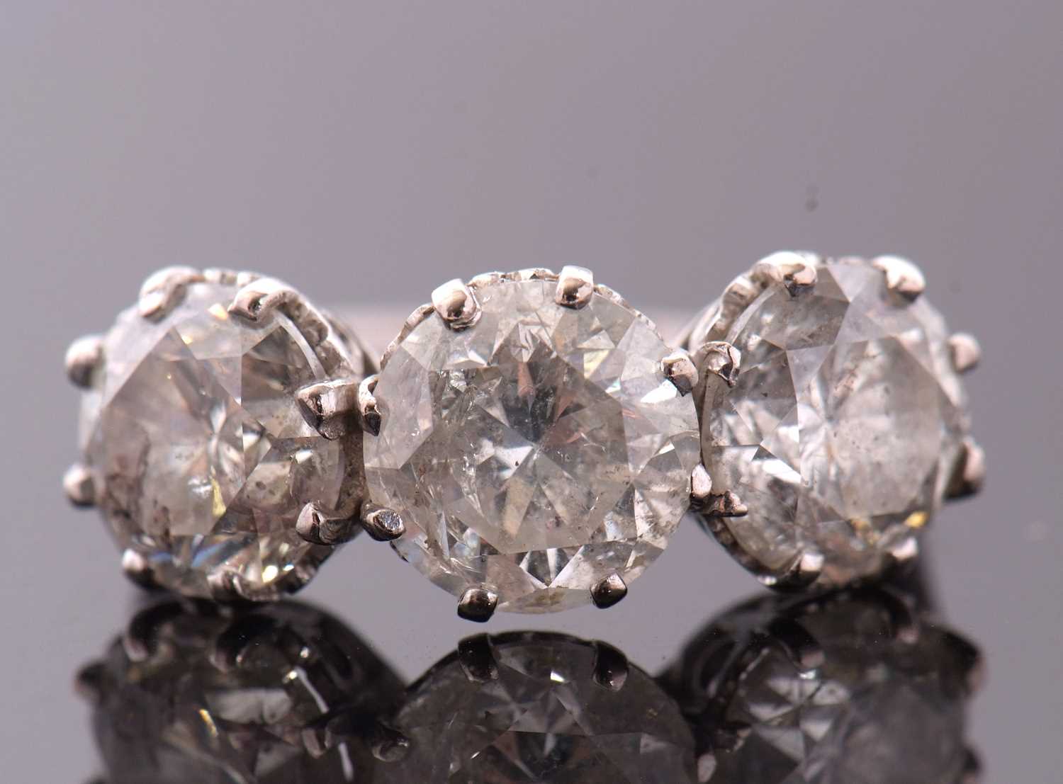 A three stone diamond ring, the three slightly graudated round brilliant cut diamonds, approx. 6. - Image 2 of 11