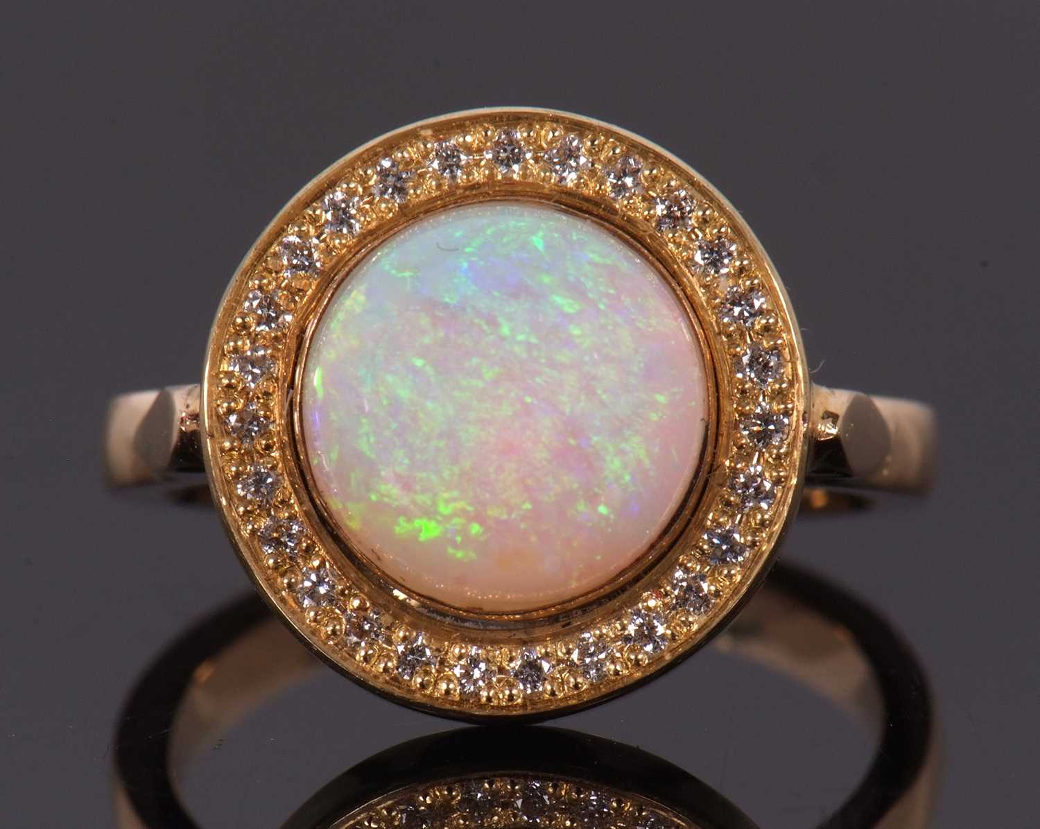 An opal and diamond ring, the round opal cabochon, approx. 9.4mm diameter, collet mounted and - Image 2 of 7