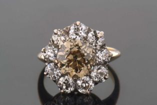 A champagne and white diamond cluster ring, the central champagne colour old European cut diamond,