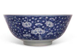 A good 19th Century Chinese porcelain bowl decorated with prunus on a blue ground, four character