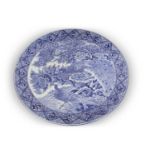 A large Japanese charger, Meiji period decorated in underglaze blue with exotic birds amongst