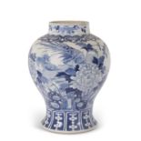 A large 18th Century Chinese porcelain jar with blue and white design of a phoenix amongst foliage