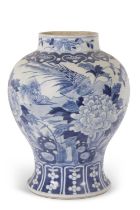 A large 18th Century Chinese porcelain jar with blue and white design of a phoenix amongst foliage