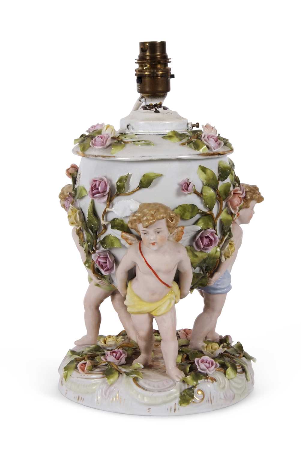 A large continental porcelain lamp base, the lamp base supported by three large cherubs with applied