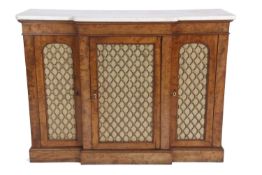 An early 19th Century faded mahogany break front side cabinet with three brass grilled doors, raised