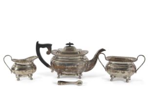 George V silver three piece tea service of plain ovoid tapering form with applied gadrooned edges