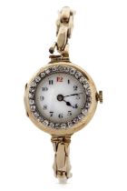 An 18ct gold cased ladies wristwatch with a diamond surrounded bezel and yellow metal expanding