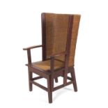 An early 20th Century oak framed Orkney chair of typical form with arched back, drop in seat and