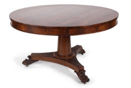 A late Regency rosewood circular breakfast or centre table, the top raised on a tapering column with
