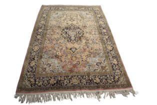 A Mid 20th Century Persian qum silk rug decorated with a three tier border with a large central