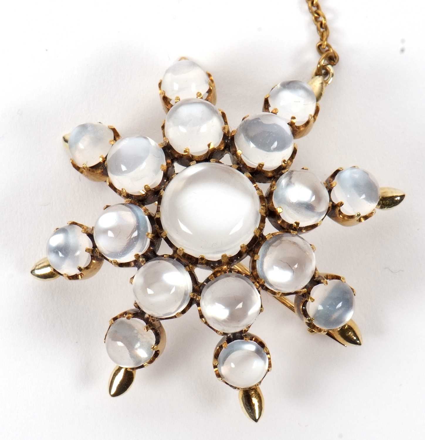 A moonstone 'star' brooch, the star shape comprised of graduated round moonstone cabochons, all claw - Image 2 of 7