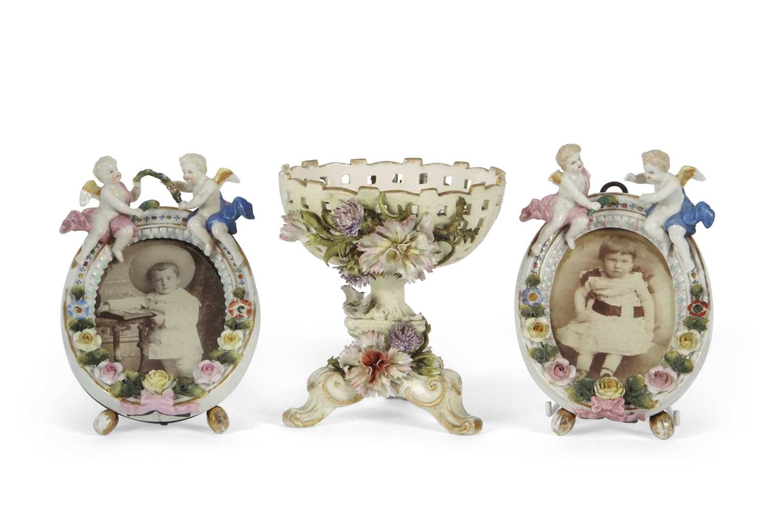 A small Sitzendorf basket with applied decoration of flowers, together with two small porcelain
