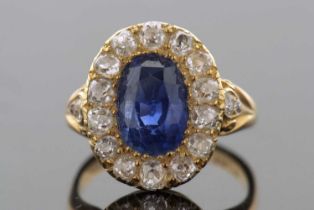 A sapphire and diamond ring, the oval mixed cut sapphire, surrounded by old mine cut diamonds, all