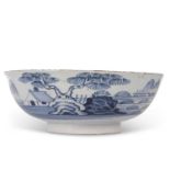 An English Delft punch bowl circa 1760 with blue and white design of house and trees in Chinese