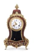 A 20th Century boulle type mantel clock with circular dial with Roman and Arabic numerals over a
