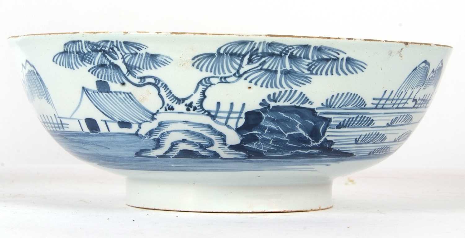 An English Delft punch bowl circa 1760 with blue and white design of house and trees in Chinese - Image 2 of 7