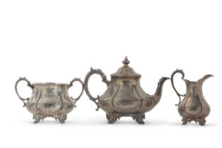 A Victorian three piece tea service of melon-fluted shape on cast scroll feet, chased and engraved