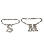 Two William IV cast silver decanter labels letters, M & S, foliate and scroll decorated and