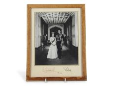 A framed signed photograph of Elizabeth II and Prince Philip dated 1976 together with a letter