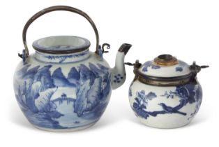 An Oriental teapot and cover with blue and white decoration and metal handle and spout together with