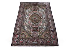 A Mid 20th Century Persian silk qum ghom seide rug, it has a floral border surrounding a large