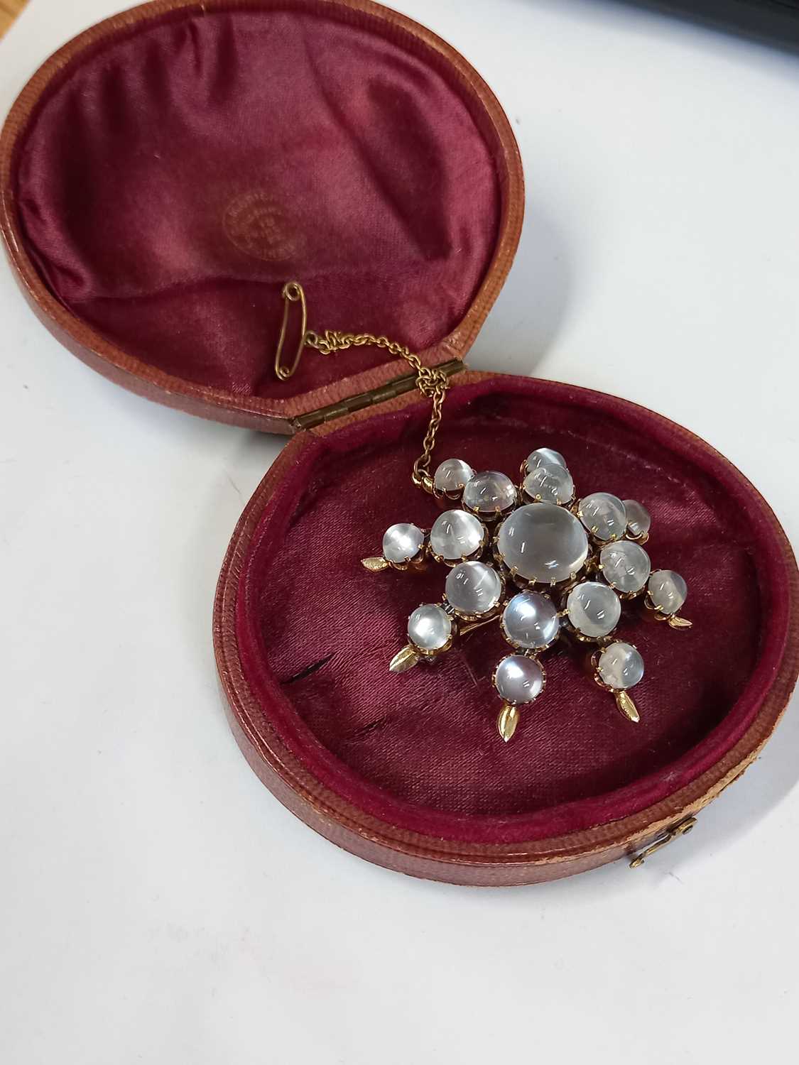 A moonstone 'star' brooch, the star shape comprised of graduated round moonstone cabochons, all claw - Image 7 of 7