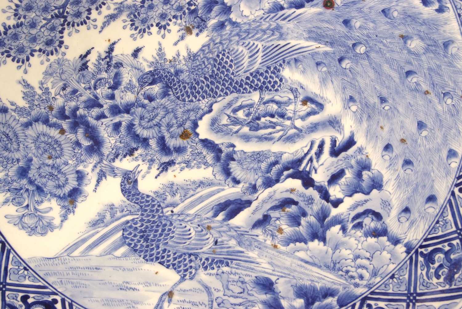 A large Japanese charger, Meiji period decorated in underglaze blue with exotic birds amongst - Image 3 of 5