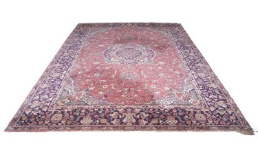 Early 20th Century wool floor rug decorated with a large central red panel surrounded by a floral