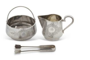 A cased Russian silver milk jug, sugar bowl and tongs, chased and engraved with floral scrolls,