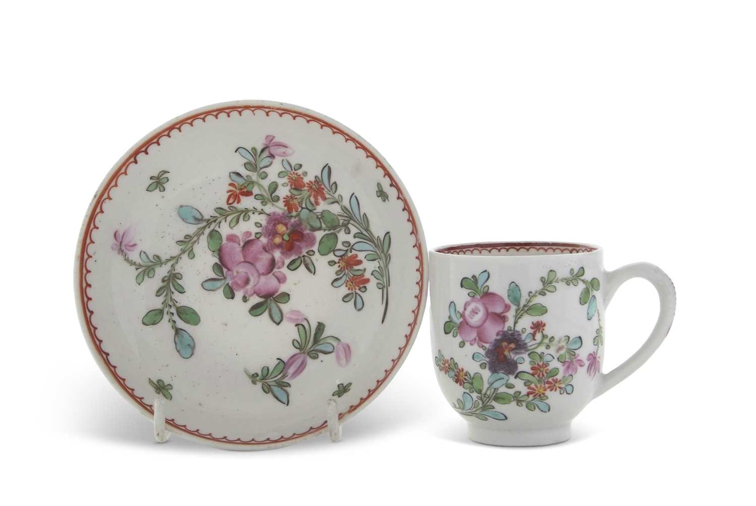 A Lowestoft porcelain cup and saucer circa 1770 with polychrome designs of flowers in Curtis
