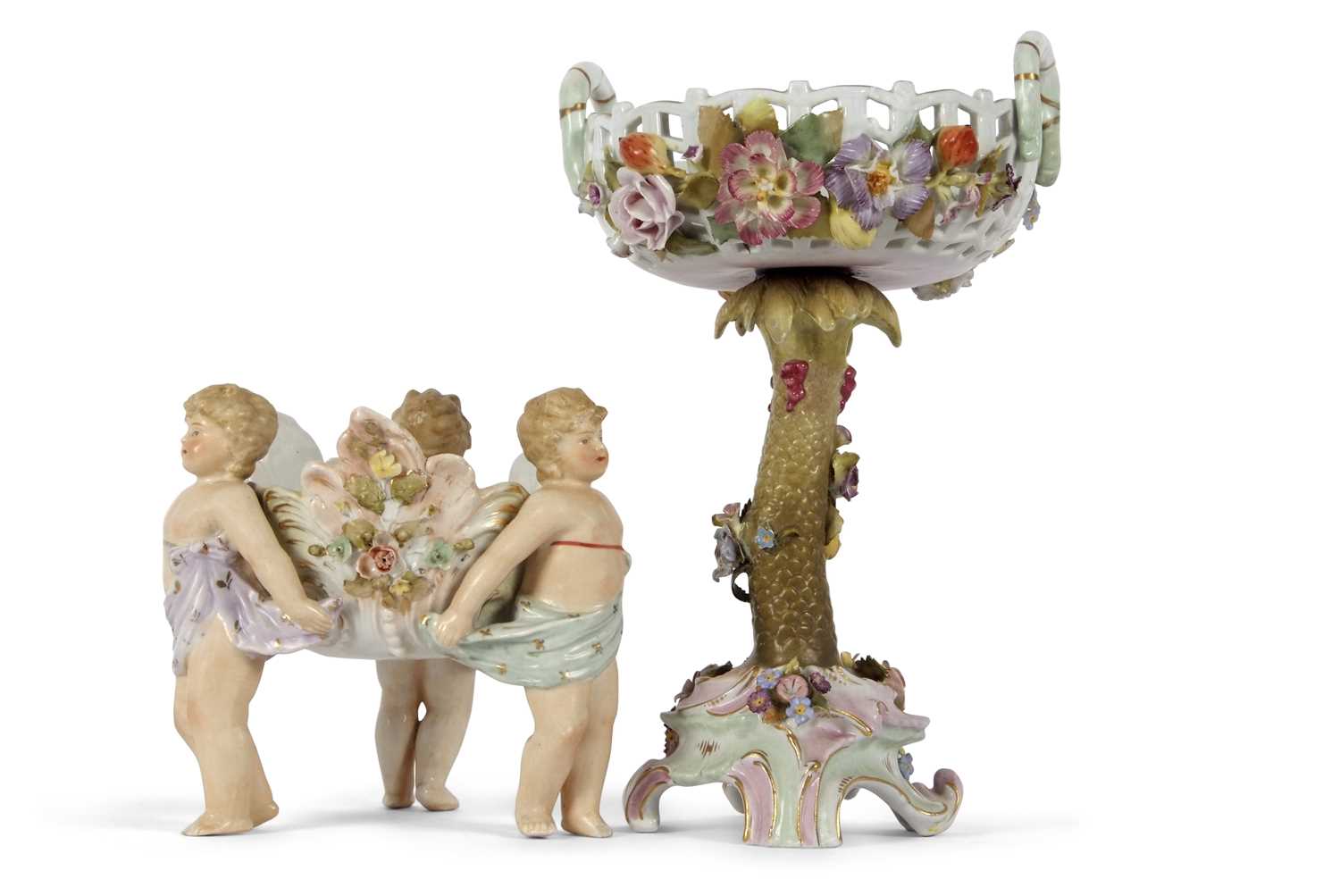 A continental porcelain centre piece modelled as a pierced basket with floral decoration on a tree