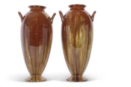 A tall pair of Linthorpe pottery vases the brown glaze with a streaked design, also with loop