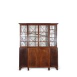 Early 19th Century mahogany break front bookcase cabinet with moulded cornice over four astragal