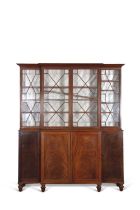 Early 19th Century mahogany break front bookcase cabinet with moulded cornice over four astragal