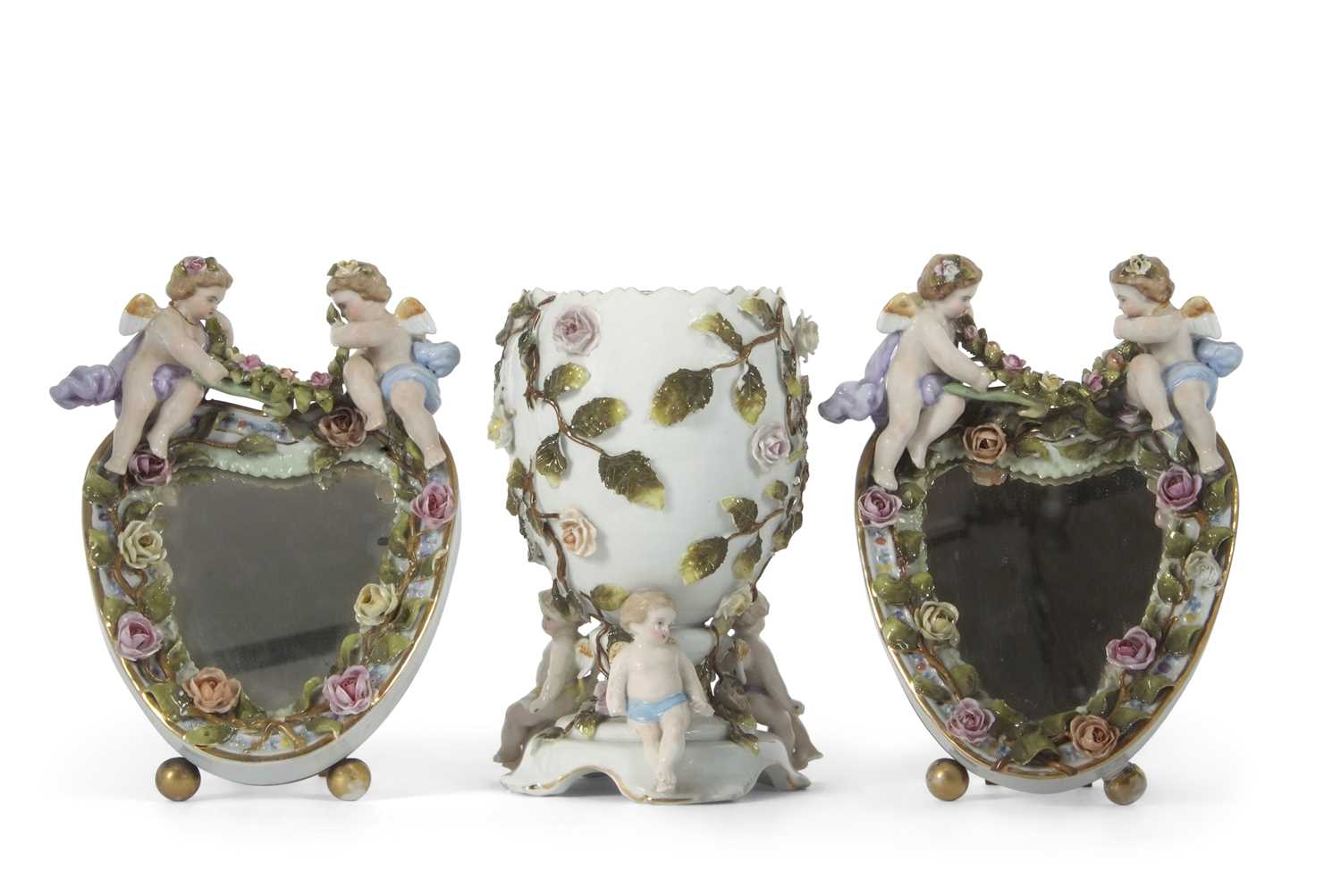 A Continental porcelain vase of oval shaped, supported by three cherubs, the base with Sitzendorf