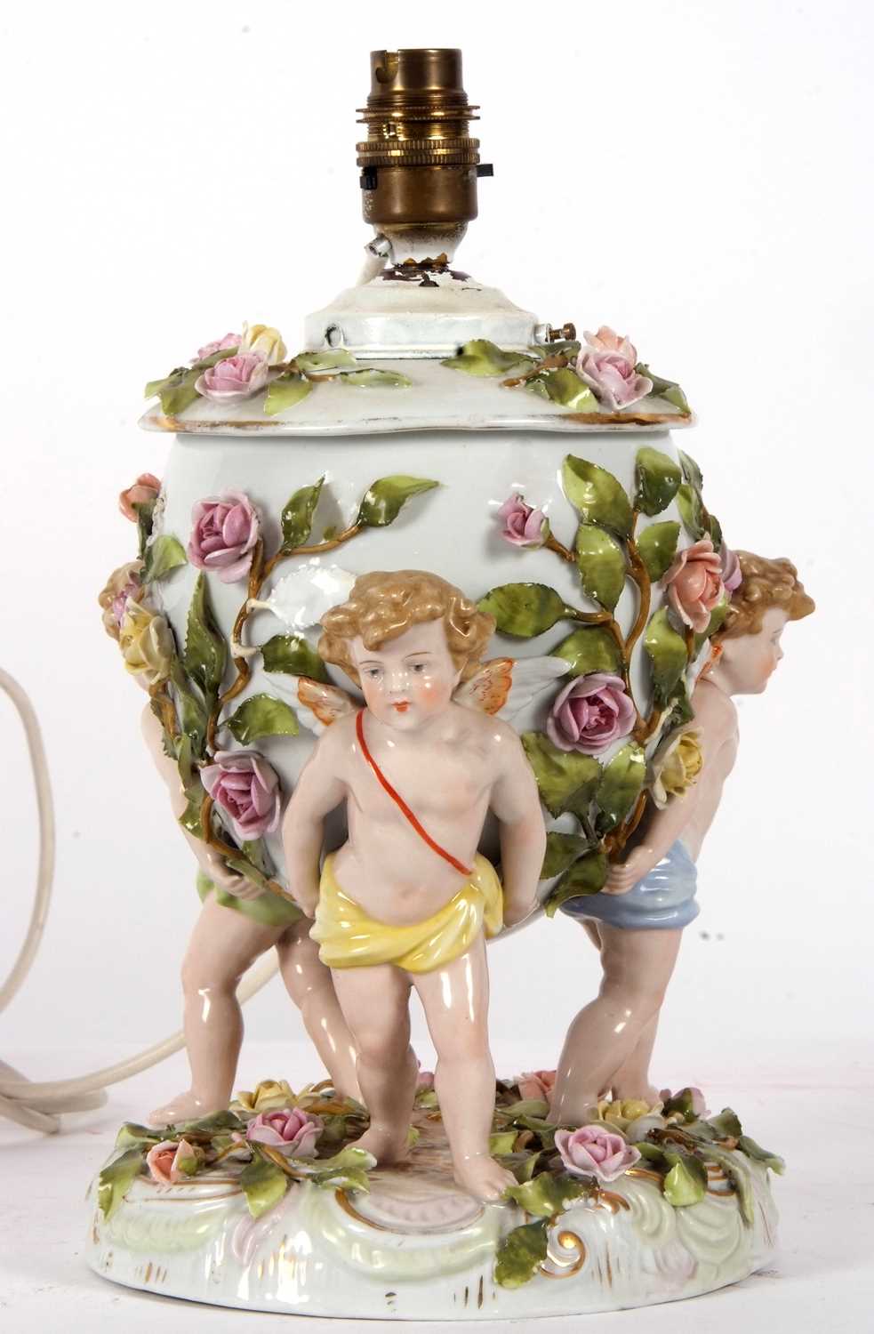 A large continental porcelain lamp base, the lamp base supported by three large cherubs with applied - Image 2 of 8