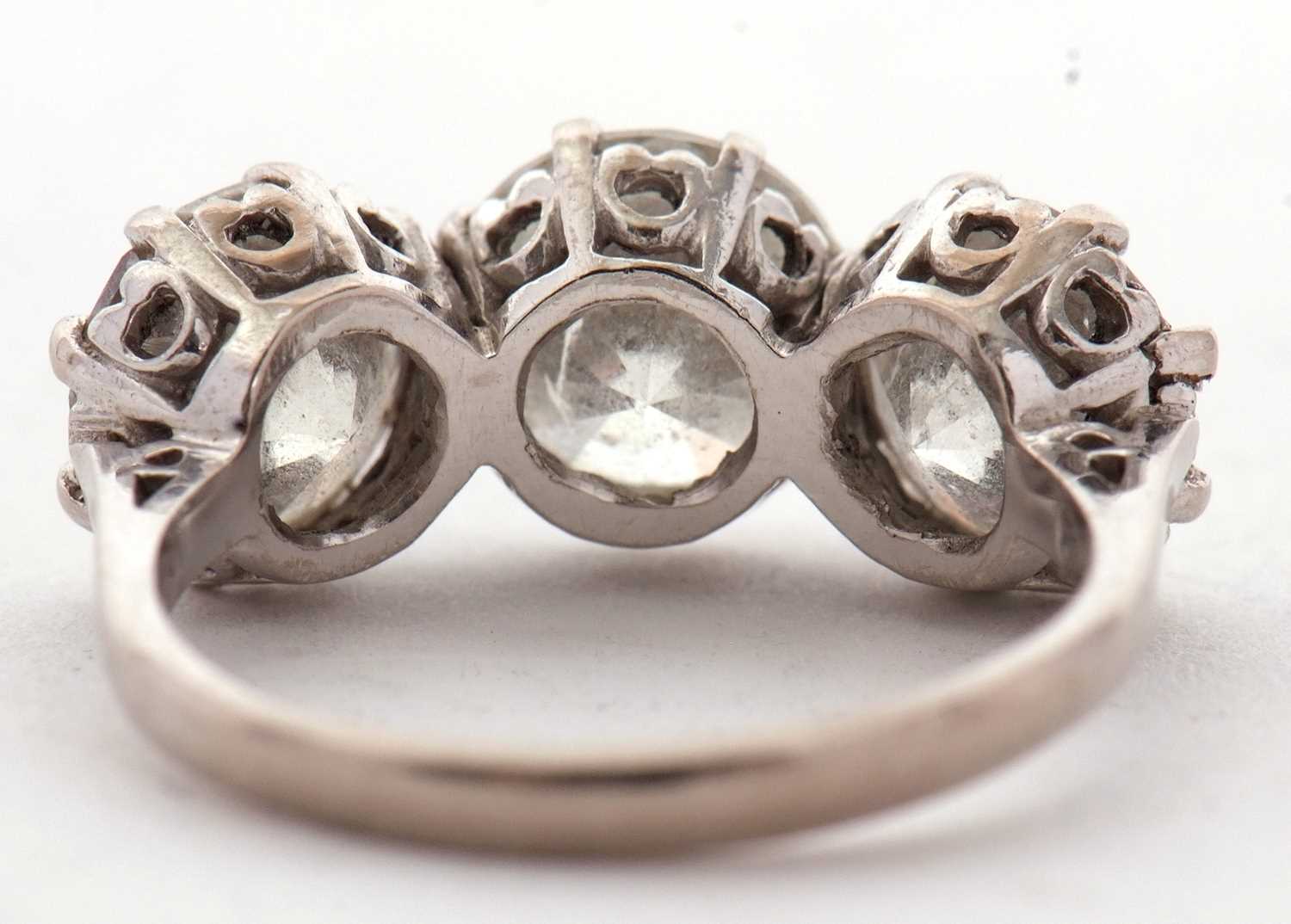 A three stone diamond ring, the three slightly graudated round brilliant cut diamonds, approx. 6. - Image 7 of 11
