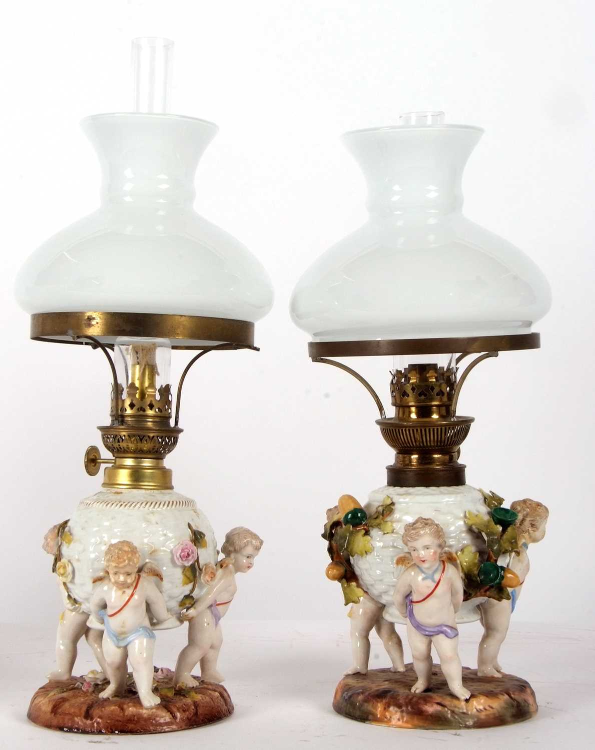 A pair of continental porcelain lamps with white frosted shades, the lamps decorated in the - Image 2 of 8