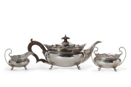 George V silver three piece tea service having plain oval baluster bodies, applied with hand-pierced
