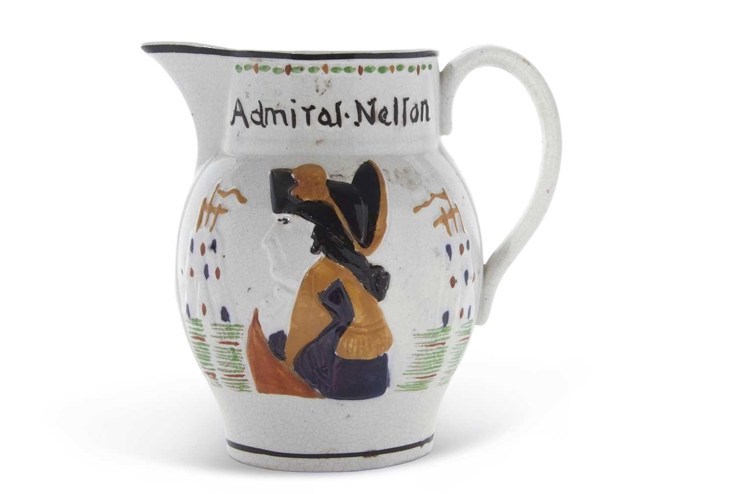 A Pratt Ware type jug modelled with Admiral Nelson in relief, the reverse with Captain Hardy, 15cm